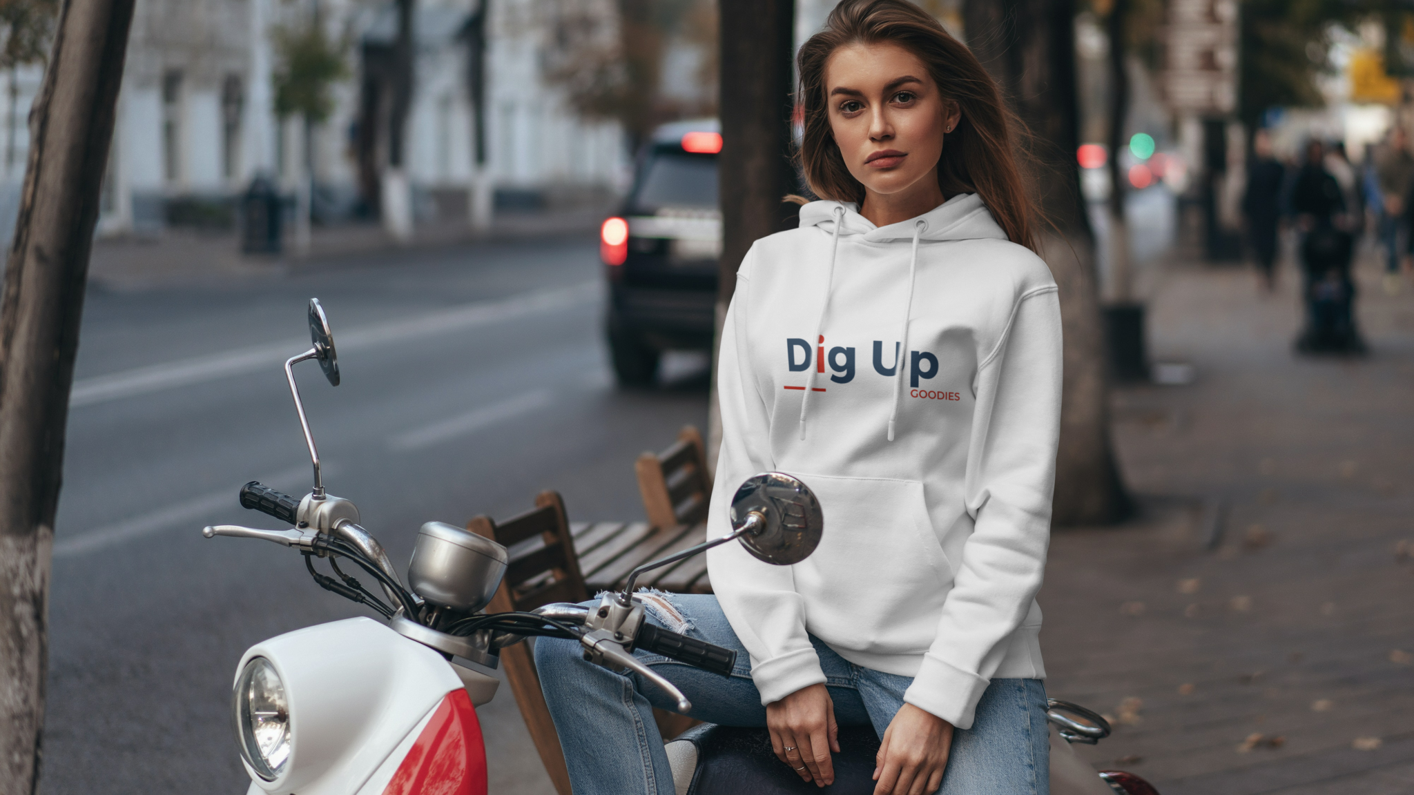 Brunette woman wearing a hoodie sitting on the motorcycle_Dig_Up-removebg-preview